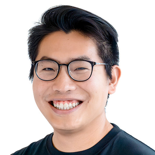 Photo of CJ Wang, one of the founders of Boardom Games, smiling in glasses and black shirt — featured in the About Us section of the party game brand.